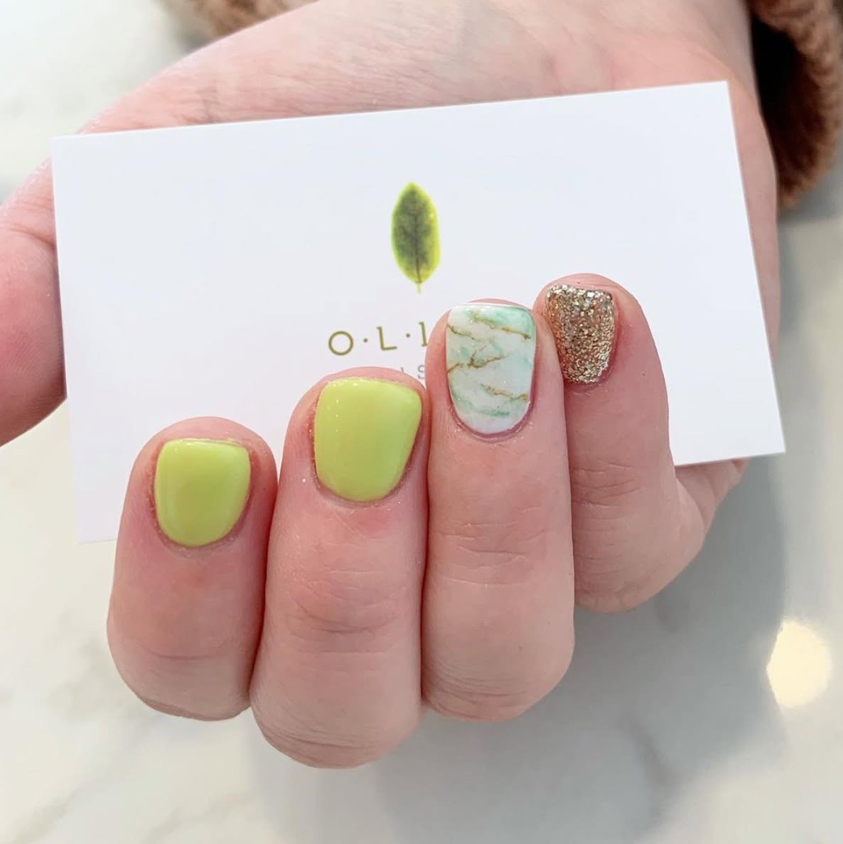 Nail art — yellow gel with marble and gold glitter accent — Olive Nails Thornhill